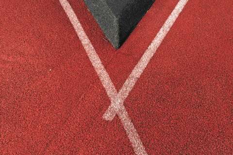 Fitnessblogs: Tartanbahn mit weißer Linie trifft auf eine graue Kante